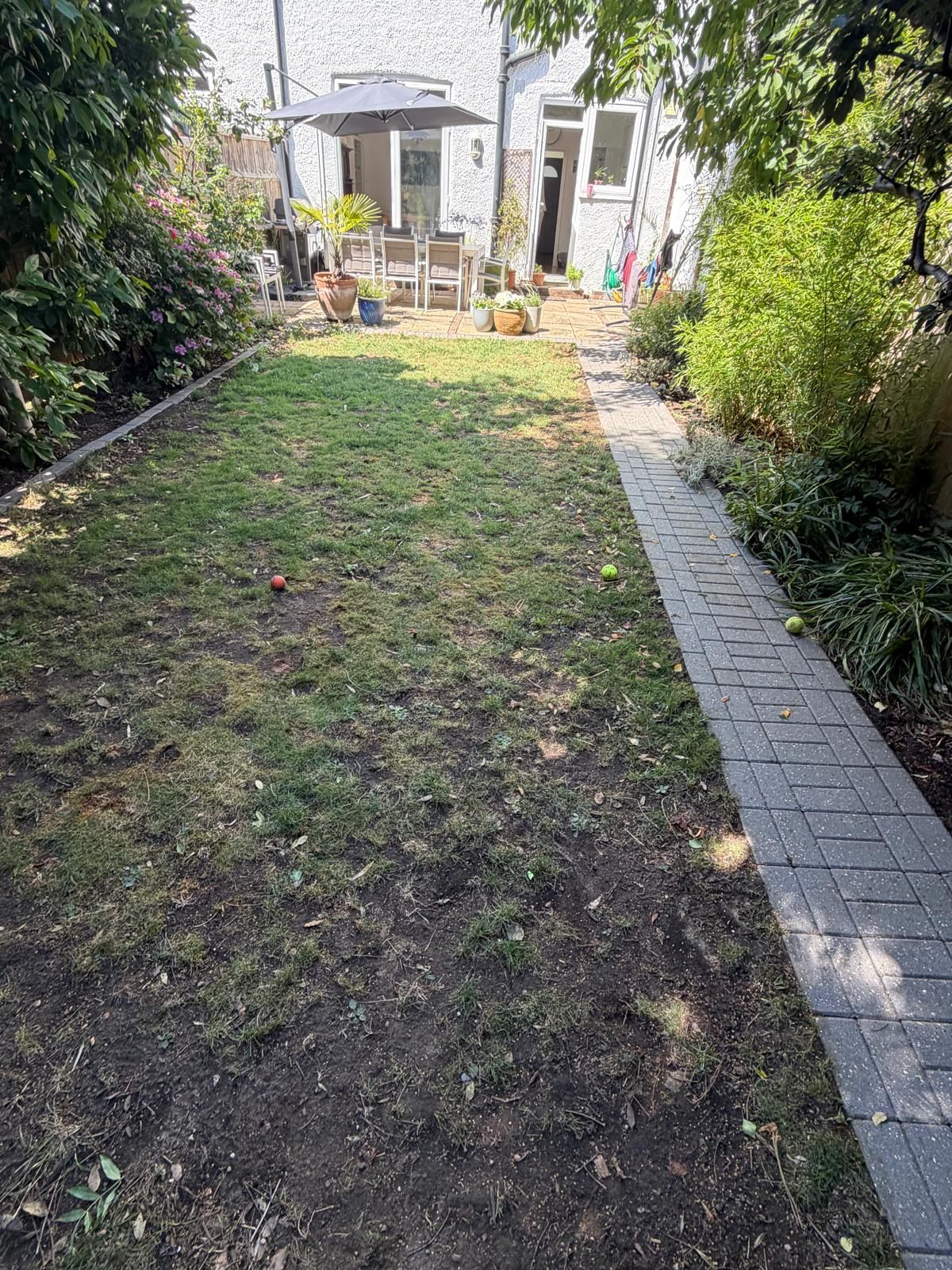 Tired patchy lawn and old block-paved path before landscaping, Surrey