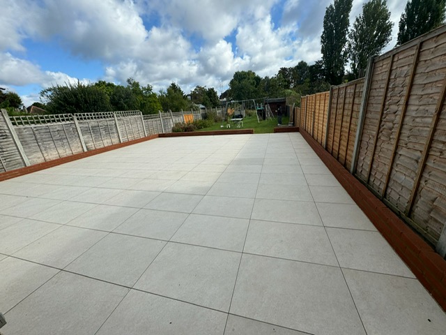 Large porcelain patio with sleeper border, Surrey